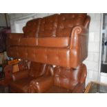 A leather effect three piece suite
