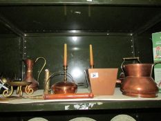 A shelf of assorted copper ware
