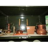 A shelf of assorted copper ware