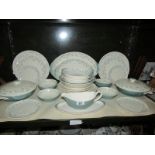 A shelf of Royal Doulton April Showers pattern dinner ware