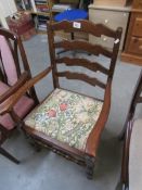 A ladder back elbow chair