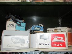 A shelf of electric irons etc