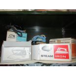 A shelf of electric irons etc