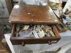 A mahogany box of costume jewellery