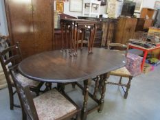 An oak gateleg table and 4 chairs