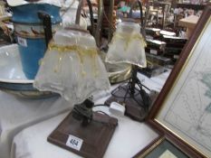 A pair of swan neck reading lamps with glass shades