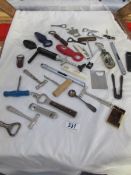A collection of corkscrews and bottle openers etc