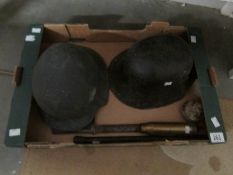 A quantity of military items including shell case, resin helmets,
