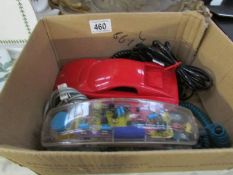 A Ferrari car telepone and a Maybell Spotlight telephone