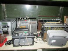 A shelf of various radio's etc