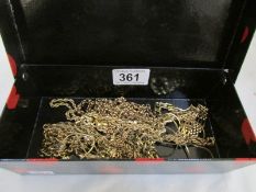 A box of yellow metal costume jewellery