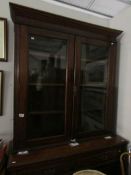 A mahogany glazed top book case