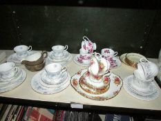 A shelf of assorted tea ware