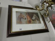 A framed and glazed print of horses