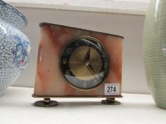 An art deco brass and marble mantel clock in working order
