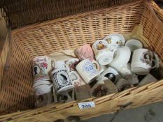 A wicker trunk containing commemorative mugs