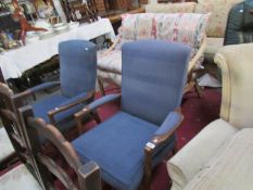 A pair of wood framed arm chairs