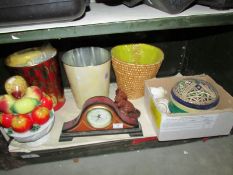 A shelf of miscellaneous items including clock