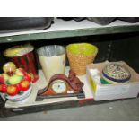 A shelf of miscellaneous items including clock