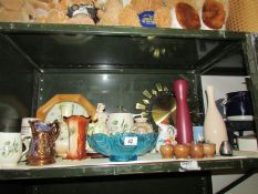A shelf of miscellaneous items including clocks