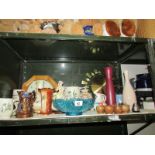 A shelf of miscellaneous items including clocks