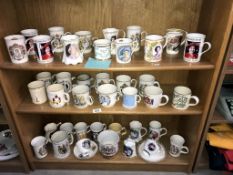 A large collection of commemorative mugs.