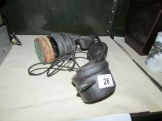 A gas mask and a field telephone.