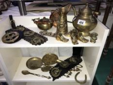 A mixed lot of brass ornaments including kettles, utensils, horse brasses etc.