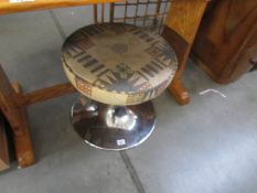 A chrome based stool.