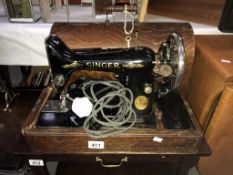 A cased Singer sewing machine.