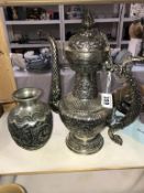A Persian white metal ewer with dragon form handle,