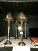 4 brass candle lamps.