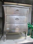 A silver coloured 3 drawer chest.