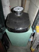A linen bin and bathroom scales,.