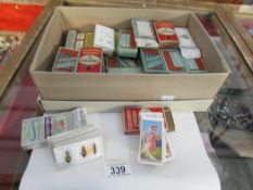 Approximately 60 packets of cigarette cards.