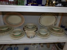 A shelf of Susie Cooper dinner ware etc.
