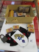 A mixed lot including cloth badges, brass buttons, old matches etc.