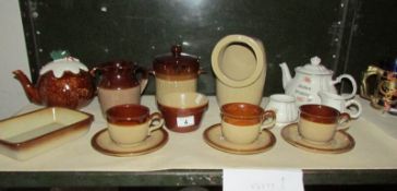 A shelf of stoneware, 3 piece tea set etc.