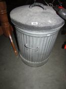 A galvanised dust bin.