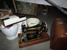A Singer sewing machine and a Kenwood mixer.