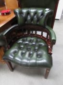 A mahogany and green leather desk chair.