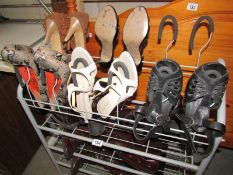 A shoe rack with vintage boots and shoes.