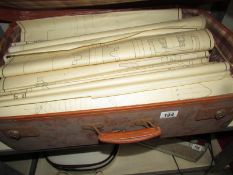 A suitcase of engineering drawings and books.