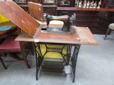 A Singer treadle sewing machine with Egyptian style decoration, a/f.
