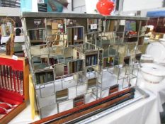 A pair of glass and metal side tables.