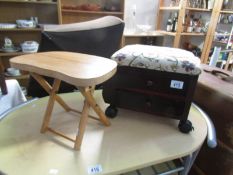 A small folding stool and a foot stool with drawers.