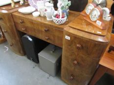 A walnut veneered dressing table,