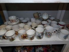 A large collection of commemorative china cups etc.