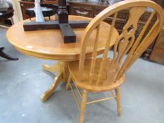 A good quality circular oak dining table and one chair.