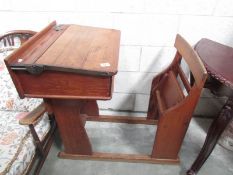 A vintage school desk incorporating seat,